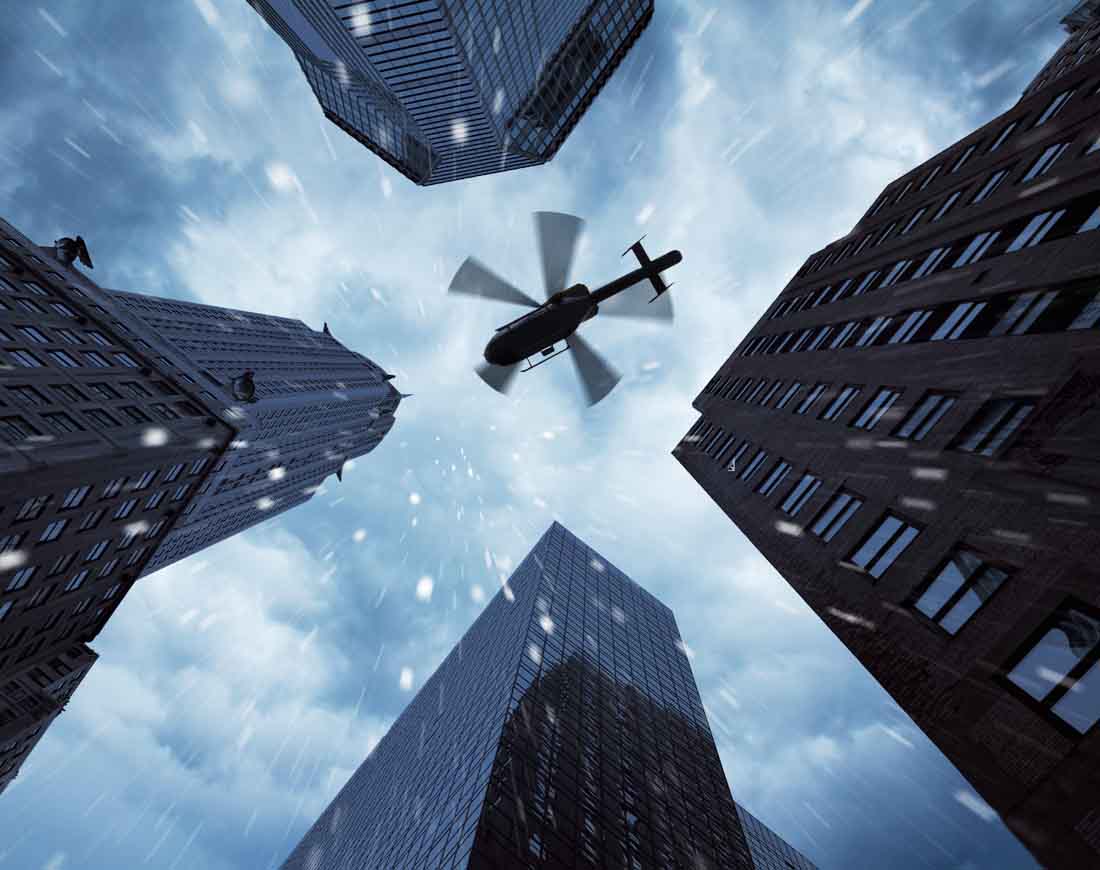 Ein Helikopter von unten im Regen zwischen Hochhäusern